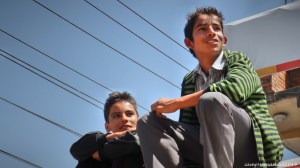 Nepalese Boys on top of a Bus ride , hitching for a free ride. on the way to Nagarkot Nepal.