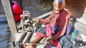 Old Lady Spinning Cotton to Yarn, the old fashion way.